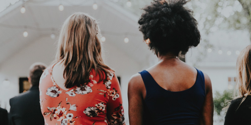 Two ladies standing in a church service